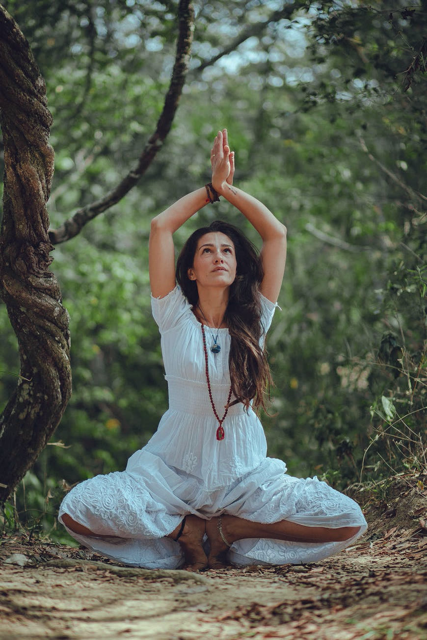 Gayle Fuller in meditation among the trees